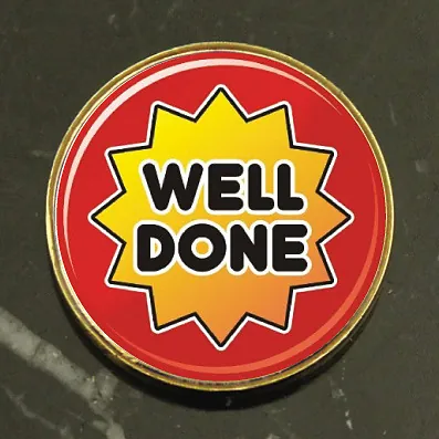 Well Done round school reward badge in red and yellow